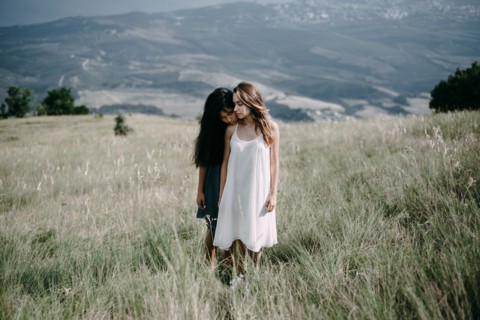 Women standing in field of tall grass