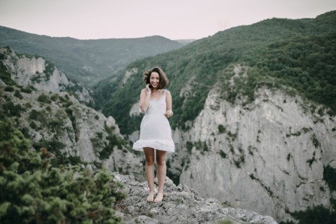 Smiling Caucasian woman standing on mountain