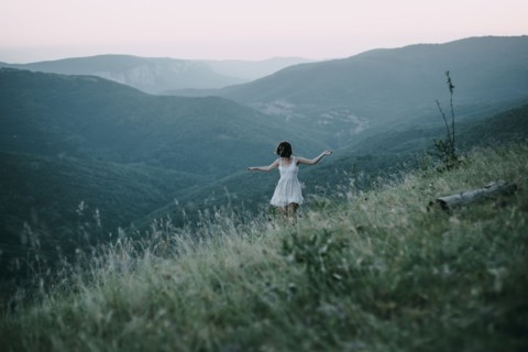 Carefree Caucasian woman walking on mountain