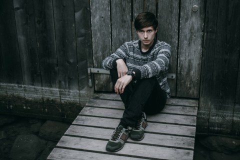 Caucasian man sitting on wooden dock
