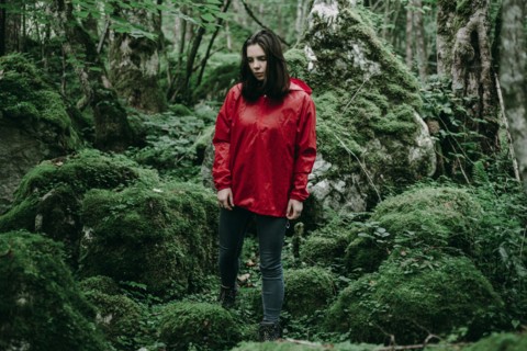 Caucasian woman standing in lush forest