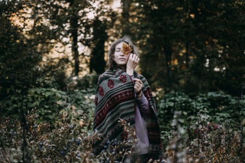 Caucasian woman holding autumn leaf