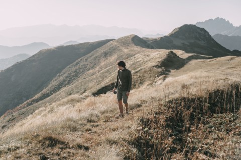Caucasian man hiking on mountain