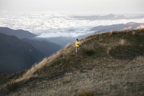 Caucasian man standing in remote mountain landscape