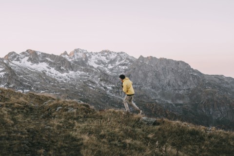 Caucasian man hiking in remote mountain landscape