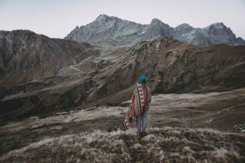 Caucasian woman standing in remote mountain landscape