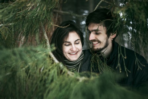 Caucasian couple smiling near tree