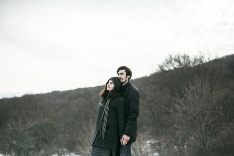 Caucasian couple standing on hill and relaxing
