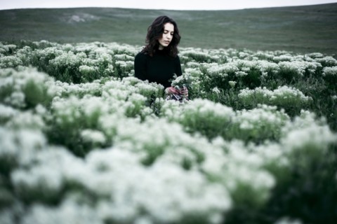 Caucasian woman standing in the field of wildflowers