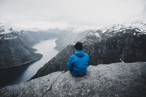 Caucasian man admiring scenic view of mountain river