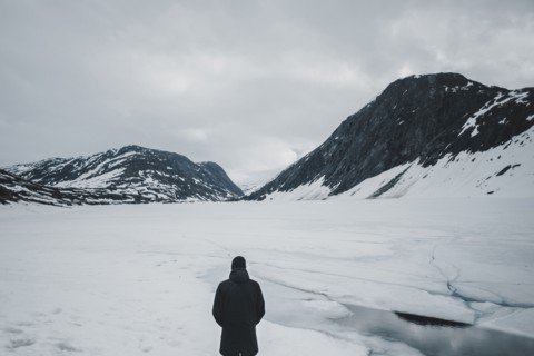 Caucasian man standing in mountain landscape in winter