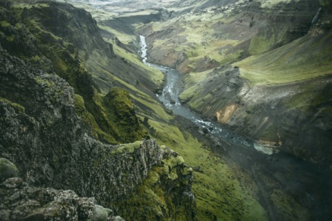 Scenic view of river in green valley