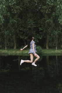 Caucasian woman floating over lake