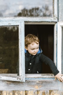 Caucasian boy opening window