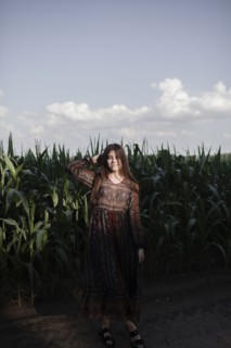 Caucasian woman standing in cornfield