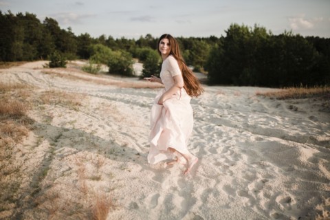 Caucasian woman running on beach