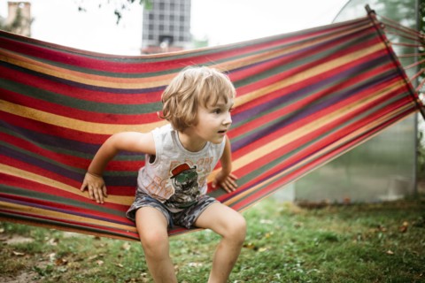 Caucasian boy sitting in hammock