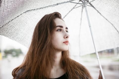 Caucasian woman holding white umbrella