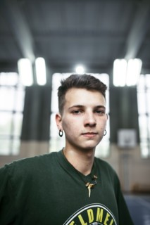 Portrait of serious Caucasian man wearing necklace and earrings