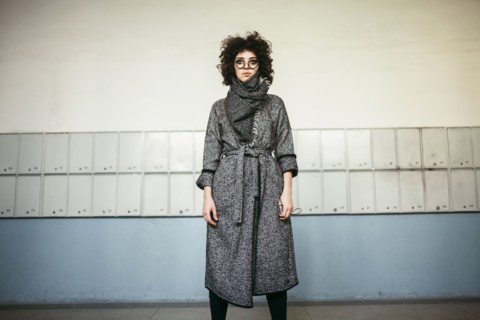 Serious Caucasian woman wearing scarf and coat
