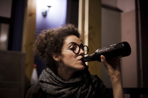 Caucasian woman drinking bottle of beer