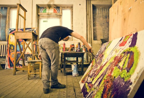 Caucasian artist painting in studio
