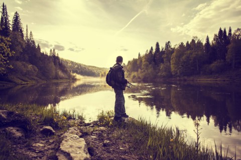 Caucasian man fishing at lakeside