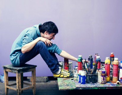Caucasian artist examining paints