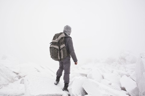 Caucasian man hiking in snow