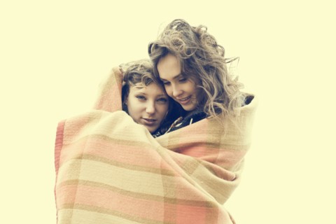 Caucasian women wrapped in blanket