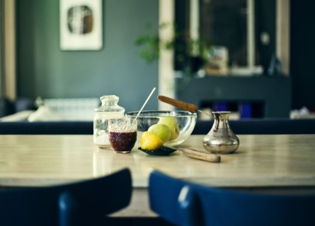Bowl of fruit with jam and sugar on table