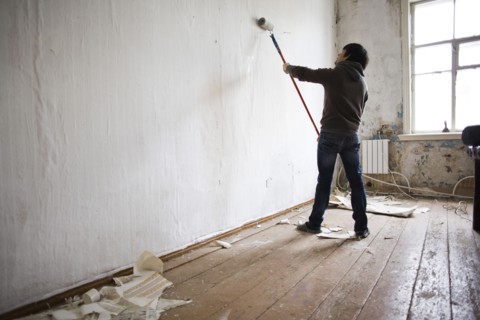 Mari man painting walls in new home