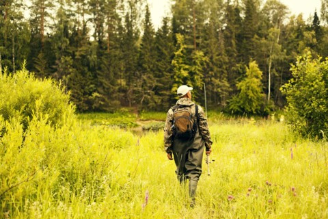 Mari fisherman walking through field