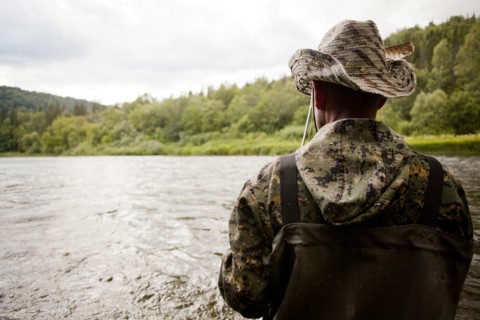 Mari man fishing in river