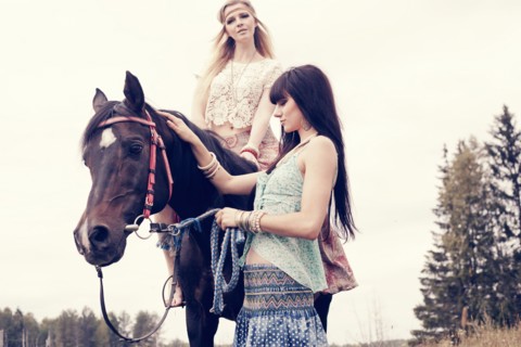 Caucasian women petting and riding horse outdoors