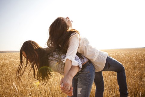 Caucasian women playing in rural field