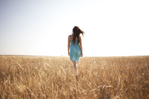 Caucasian woman walking in rural field