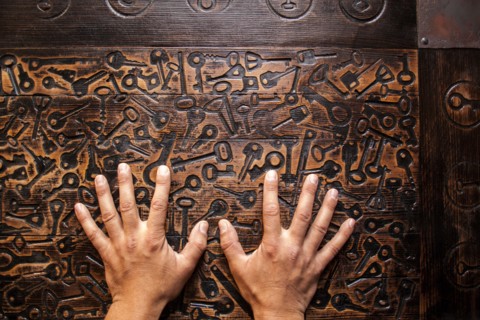 Close up of hands of Mari man hands on wooden surface