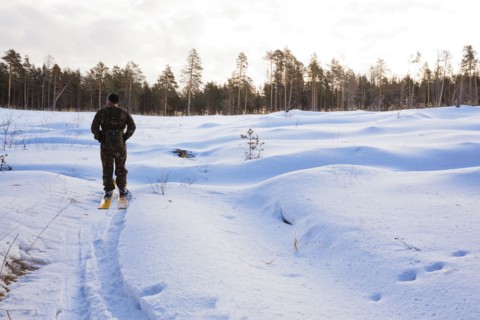 Caucasian man cross country skiing in snowy field
