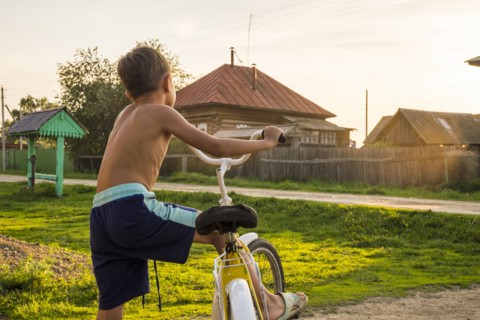 Mari boy riding bicycle