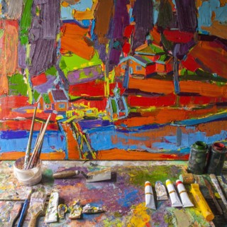 Painting on easel with paint and paintbrushes