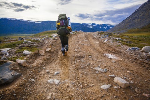 Mari backpacker walking on dirt path