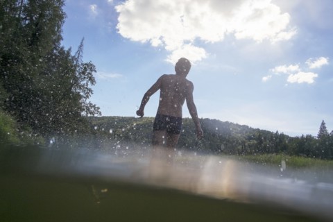 Mari man wading in lake