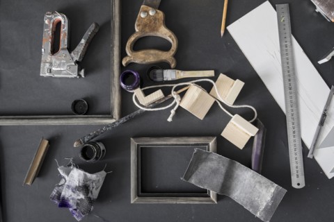 Picture frame and tools on table