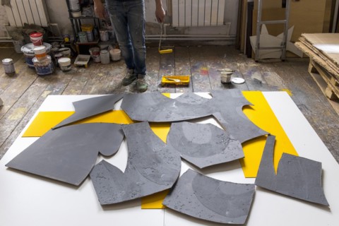 Caucasian artist painting with paint roller