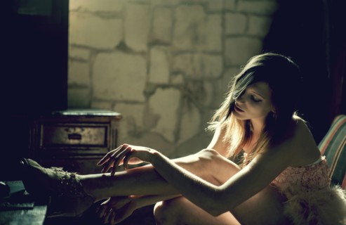 Pensive Caucasian woman examining leg