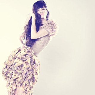 Serious Caucasian woman wearing ruffled skirt