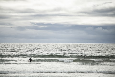 Surfers in ocean waves