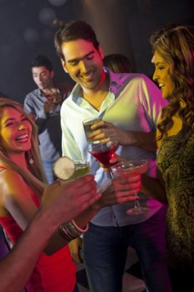 Hispanic friends drinking cocktails in bar