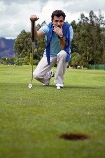 Hispanic man assessing golf course